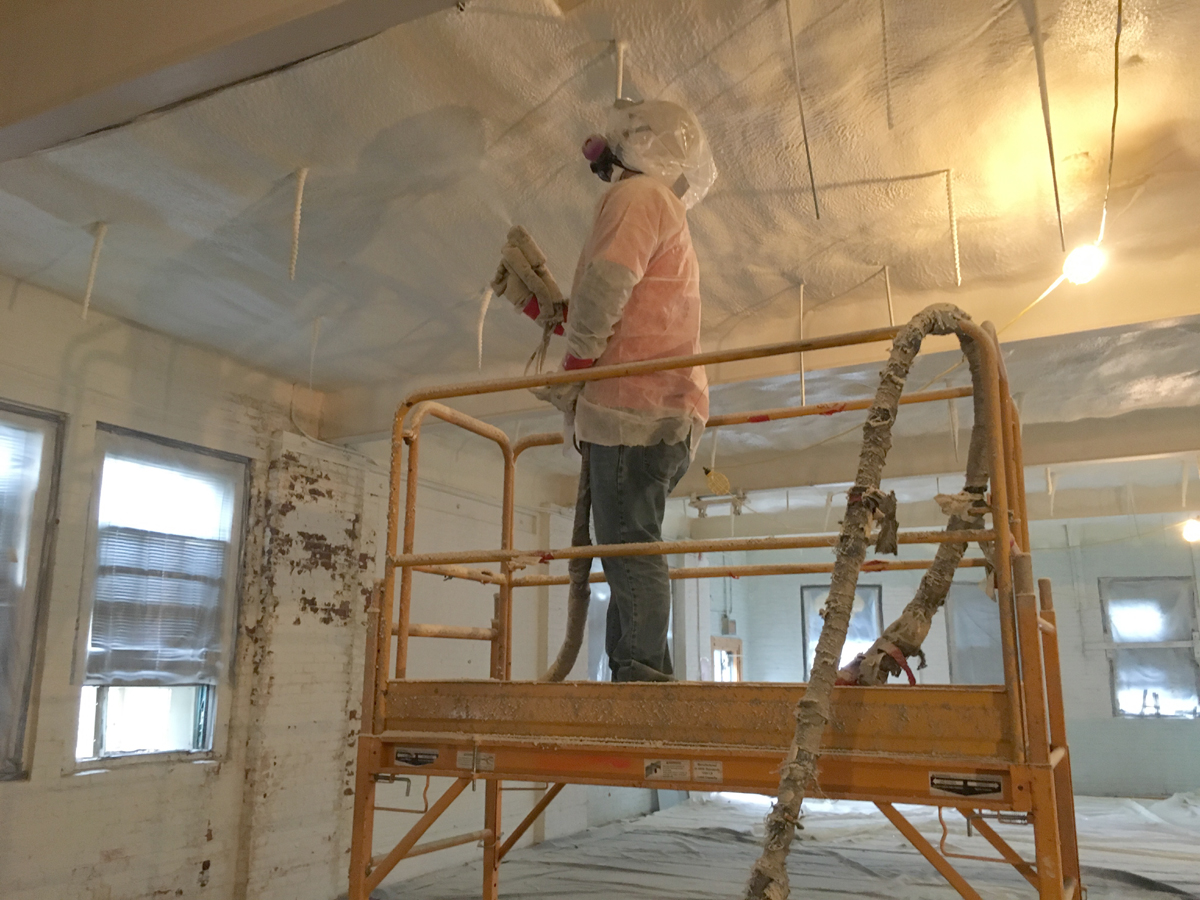 our workers completing spray foam acoustic insulation